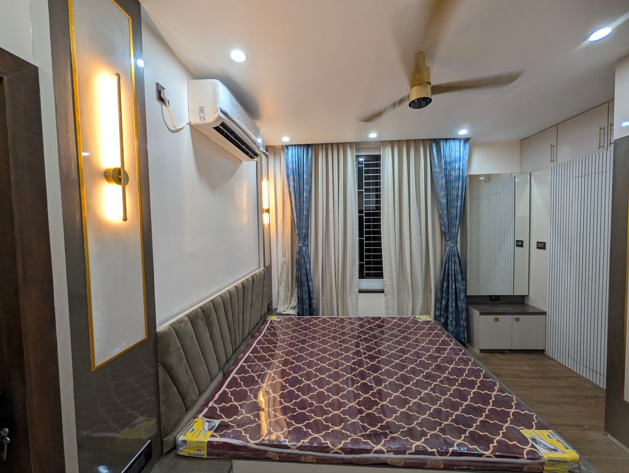 Bedroom feature wall with marble-finish panel and brass geometric detailing, Aim Interiors Dumdum project